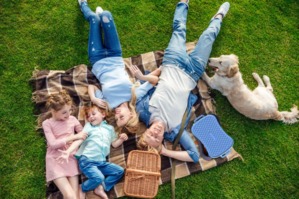 Family on picnic rug with dog and Slow Feeder Dog Bowl